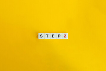 Wall Mural - step 2 banner and concept. letter tiles on yellow background. minimal aesthetic.