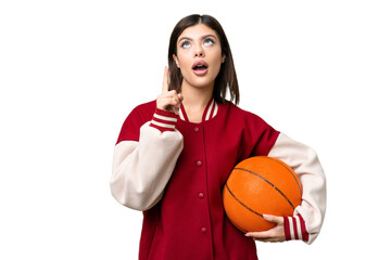 Wall Mural - Young Russian woman playing basketball over isolated chroma key background thinking an idea pointing the finger up