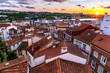 Roofs of Coimbra upper city against dramatic sunset in Portugal