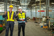 © BESTIMAGE - Two professional engineer worker technician assistant in helmet inspection check old machine construction factory with colleague manager. check old machinery production construction operating
