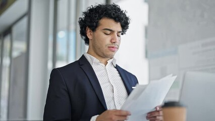 Sticker - Young latin man business worker reading document receiving dollars at office