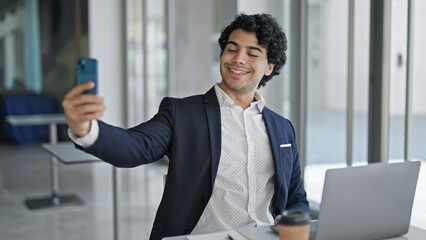 Sticker - Young latin man business worker using laptop make selfie by smartphone at office