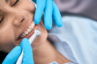 Close-up woman visiting dentist, stomatologist holding drill, cleaning fissures