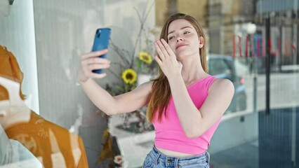 Poster - Young blonde woman smiling confident making selfie by the smartphone at clothing store