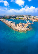 Mandraki Port With Fort Of St. Nicholas And Windmills, Rhodes, Greece. 