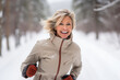 © Kalim - Ai generated image of mature senior woman running in winter