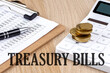 TREASURY BILLS text with chart and calculator and coins , business concept