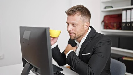 Canvas Print - Young man business worker using computer drinking coffee at office