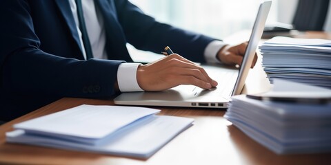 Aufkleber - An office manager or accountant sits at a table, makes documents, enters data into an electronic system on a laptop.