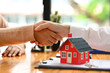 Realtor or landlord shaking hands with client after sign agreement or sale purchase contract.