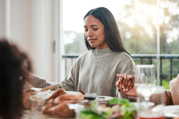 Canvas Print - Woman, praying and holding hands at family dinner at thanksgiving celebration at home. Food, female person and eyes closed at a table with religion, lunch and social gathering on holiday in house