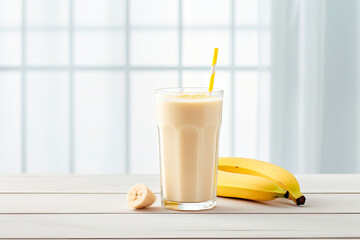 Wall Mural - banana smoothie with oats seeds in glass on white surface