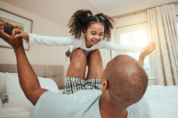 Wall Mural - Dad, child and playing on bed flying for fun, quality time or bonding together in home, bedroom or girl in airplane game. Happy, father and daughter in air with knees and arms raised with freedom