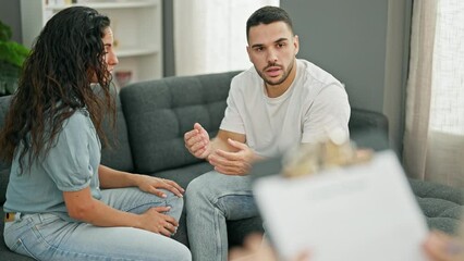 Poster - Man and woman sitting on sofa having couple therapy at psychology clinic