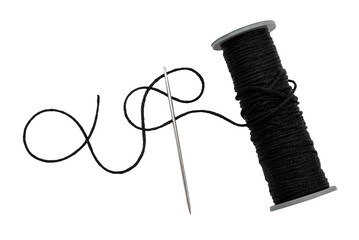 plastic spool with black synthetic threads close-up. needle and thread