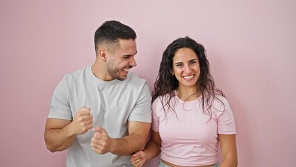 Sticker - Man and woman couple smiling confident celebrating over isolated pink background