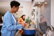 © Monkey Business - Mother With Teenage Daughter Helping To Prepare Meal At Home In Kitchen Together