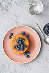 Wall Mural - Pancakes with blueberries and honey top view