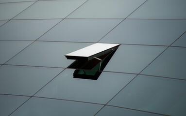 Wall Mural - A half-open window on the side of a building, surrounded by a modern, grey glass structure