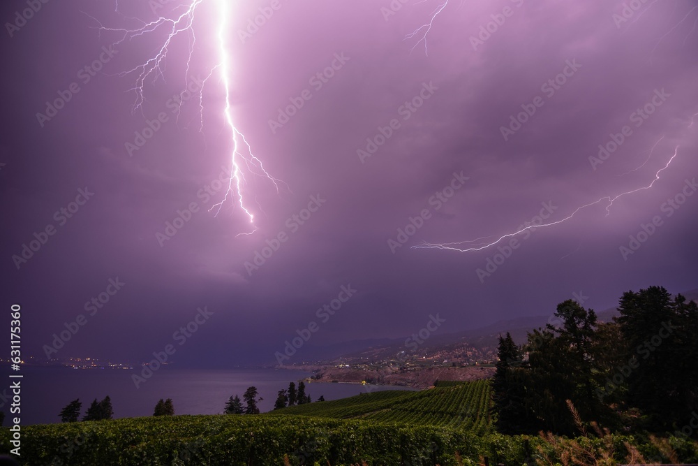 Dramatic image of a stormy lightning sky over Okanagan Lake and the ...