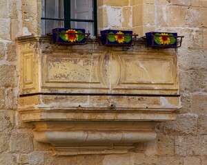 Poster - Window with several colorful flower pots sitting on its ledge.