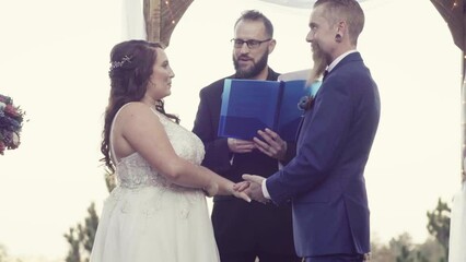 Canvas Print - Marriage officiant reading wedding vows during the marriage ceremony in the garden
