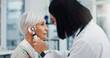 © SneakyPeakPoints/peopleimages.com - Senior woman, doctor and otoscope for ear, hearing test and exam, audio check or consultation for healthcare. Ent, otolaryngology and medical professional with elderly person for wellness in hospital