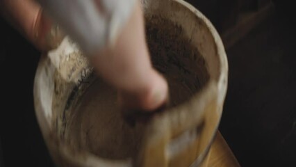 Sticker - Close-up view of a person wetting hands to work with a sourdough