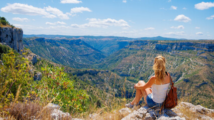 Wall Mural - Woman tourist enjoying panoramic view of France landscape- travel, tour tourism, adventure concept- Cirque de Navacelles, Herault, Larzac in France