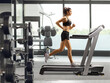 © Ljupco Smokovski - Fit young female running on a treadmill in a gym
