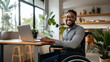 Middle-aged man in a wheelchair works from his home office.