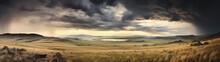 Panoramic Image Of A Vast, Windswept Grassland Under A Stormy Sky, A Vast Landscape Under A Dramatic Stormy Sky, Where Sunlight Pierces Through, Illuminating The Golden Fields.