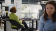 © DC Studio - Team leader using internet remote conference on pc, talking to corporate employees about growth. Female entrepreneur chatting on teleconference call, videocall meeting in coworking space.