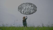 Woman Discovering Virtual Abstract Floating Cloud Cloth Outdoors