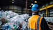 Engineer observing plastic bottle in recycling industry