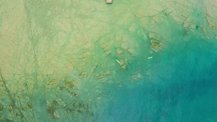 Wall Mural - Vertical aerial view of the jagged and rocky coast of Lake Garda near Sirmione