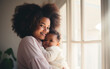 © Malchevska Studio - Black african american dark-skinned happy loving mother hugging her baby at home