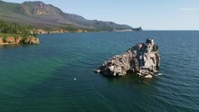 A Beautiful View Of A Picturesque Rocky Island With Nests Of Seagulls And Cormorants On Lake Baikal. The Wild Nature Of Summer Lake