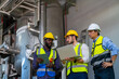 © CandyRetriever  - Group of Diversity electrical engineer in safety uniform working together at factory site control room. Industrial technician worker maintenance and checking power system at manufacturing plant room.
