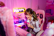 © CandyRetriever  - Young Asian woman esport player playing online game on computer in bedroom. Attractive girl vlogger influencer gamer enjoy and fun live streaming broadcast games challenge on social media platform.