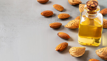 Wall Mural - Banner Almond vegetable oil in a flask with almond nuts around. The concept of healthy eating. Copy space.