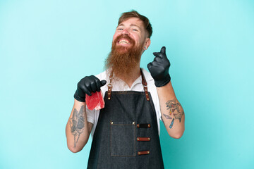 Wall Mural - Butcher man wearing an apron and serving fresh cut meat isolated on blue background making money gesture