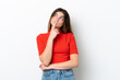 © luismolinero - Young caucasian woman isolated on white background having doubts while looking up