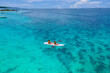 © Fokke Baarssen - Mauritius vacation, couple man and woman in a kayak in a blue ocean in Mauritius. men and women peddling in a turqouse colored ocean of the Island of Mauritius