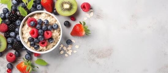 Aufkleber - A healthy breakfast of oatmeal topped with berries and fruits is shown on a light background. taken