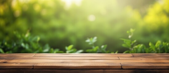 Fototapete - A table made of wood with space to showcase your product and a sunny and green background. It can