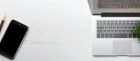 Aufkleber - A top-down view of a modern white office desk with a laptop computer, a smartphone with a black