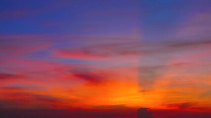 Wall Mural - colorful sunset blue red orange yellow sky with dark orange cloud and ray on right frame
