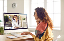Female Patient Having Online Medical Consultation Via Video Call On Computer. Young Woman Sitting In Front Of Screen, Talking To Remote Doctor And Asking Advice About Sore Throat. Telemedicine Concept