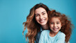 © Studio Nova - Happy mother and daughter smiling and hugging against the blue background. Created with Generative AI technology.